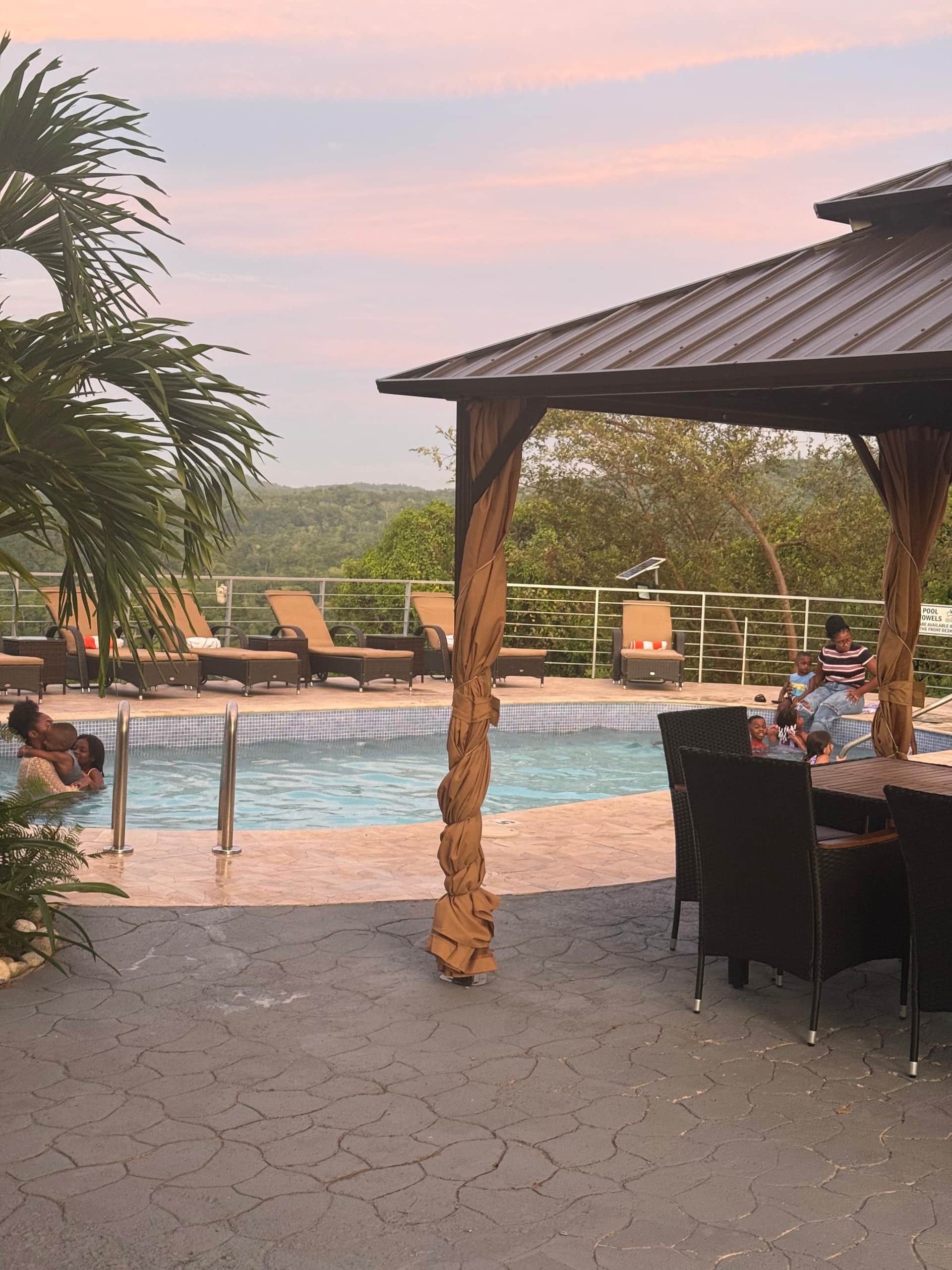Tables by the pool gazebo at dusk